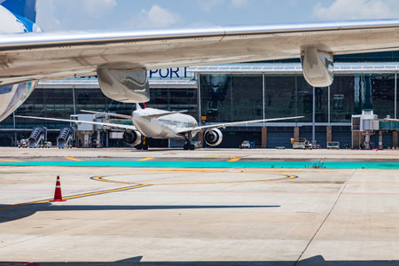 close-up on the wing of a passenger aircraft with a turbine at the airport in thailand. travel and...
