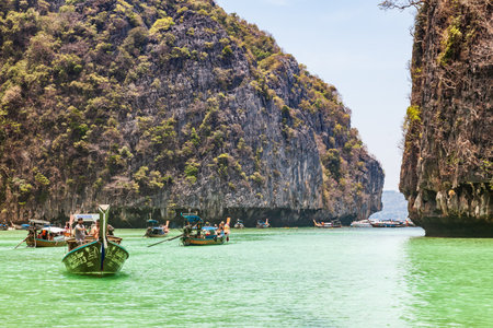 Thailand, Phuket - 04.01.23: A picturesque beautiful place on the island of Phi Phi Leh - Pi Leh Lagoon is popular for excursions with tourists on traditional Thai fishing boats. island travel in thailand.のeditorial素材