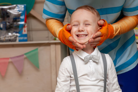 An animator puts a smile on a childs face while playing at a boys birthday party.の写真素材