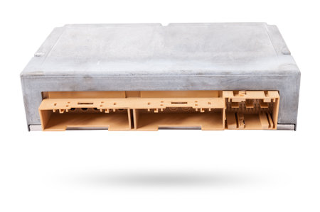 Plastic car engine control unit with metal elements on a white isolated background is the connecting center of various subsystems, units and assemblies. Monitoring the state of the moment. Spare partの写真素材