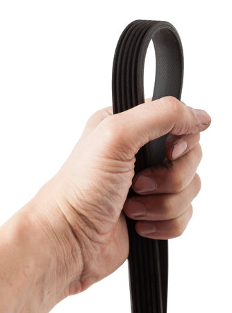 V-ribbed engine belt made of black rubber on a white isolated background in a photo studio of auto parts for replacement during repair or for a catalog of spare parts for sale on auto analysis.の写真素材