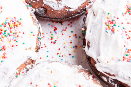 Top view of four freshly baked Easter cakes close-up with traditional confectionery decoration white...
