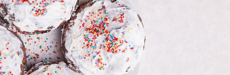 Top view of four freshly baked Easter cakes close-up with traditional confectionery decoration white...