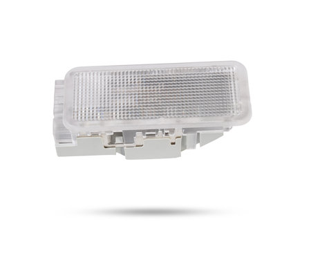 A transparent plastic shade for illuminating the interior on a white isolated background in a photo studio - spare parts for repairing a car interior or for sale in a auto service.の写真素材