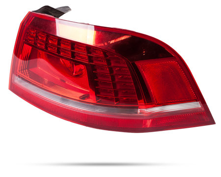 A taillight of a stop signal - optical equipment of white and red color on a white isolated background. A spare part for repair and sale in a car service center.の写真素材