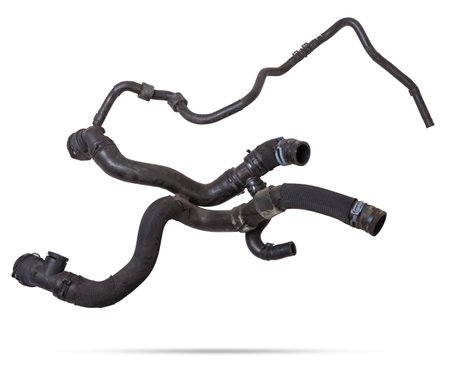 Black plastic hose of the car engine cooling system on a white isolated background in a photo studio for replacement during repair or for a catalog of spare parts for sale on auto disassembly.の写真素材