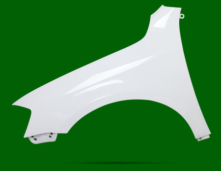 White plastic fender on a green chroma key isolated background in a photo studio for sale or replacement in a car service. Mudguard on auto-parsing for repair or a device to protect body from dirt.の写真素材