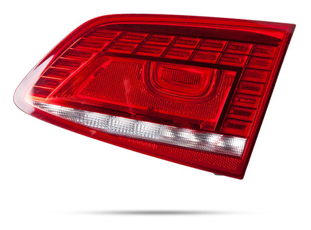 A taillight of a stop signal for a German auto - optical equipment of white and red color on a white isolated background. A spare part for repair and sale in a car service center.の写真素材