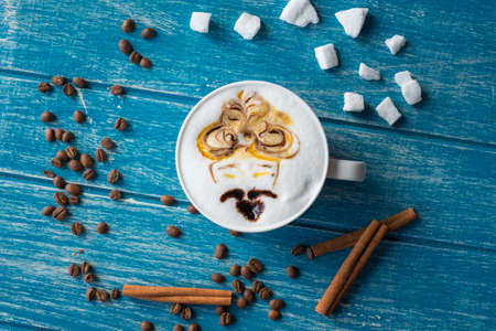 Cup of coffee with sugar and cinnamon on a blue background