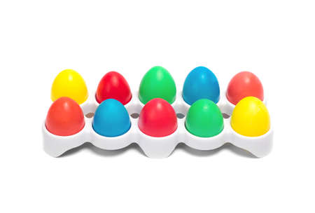 Easter colored eggs in white stand on the white background