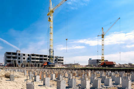 Construction cranes blue and yellow on a background of blue sky