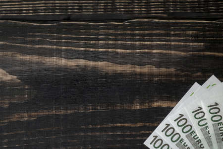 Euro banknote on a dark old wooden backgroundの写真素材