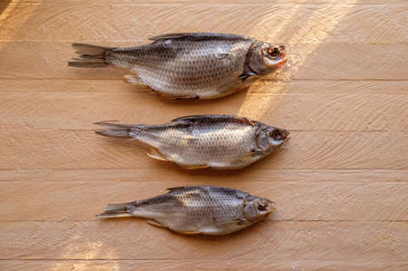 Dried fish on a wooden background in daytime