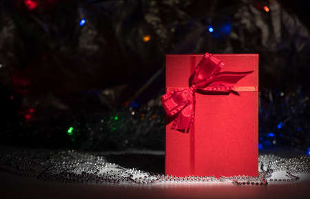 Gift box on table. Use it in the luxury gift certificate background or in a birthday, valentine or Christmas box design. New Year.の写真素材