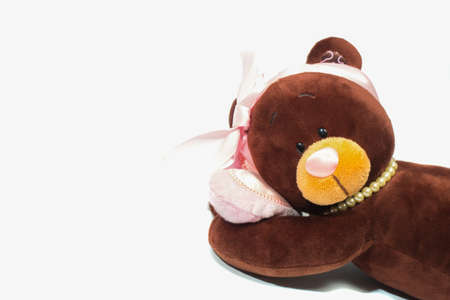 Plush toy bear lying on its side with a pink heart on isolated white background. Valentine dayの写真素材