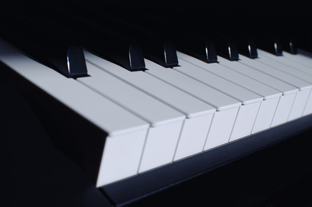 a piano instrument, black and white keys with a blue tintの写真素材