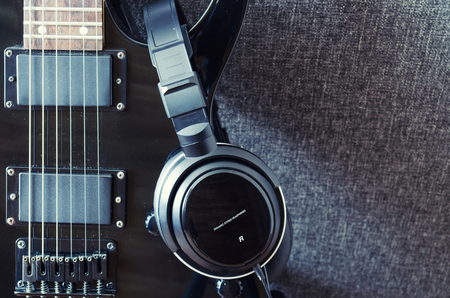 black electric guitar and headphones for music recordingの写真素材