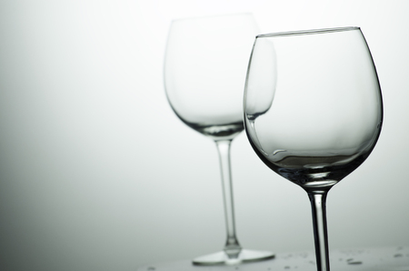 two wine glass on the illuminated backgroundの写真素材
