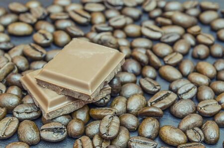 Coffee beans and chocolate in the background