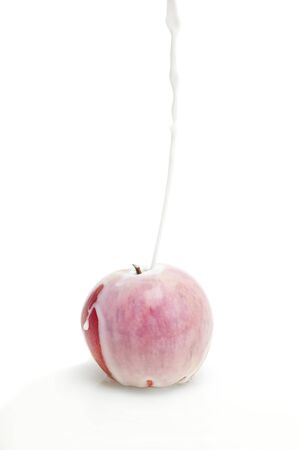 fresh apple in a stream of fresh milkの写真素材