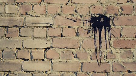 texture of a brick wall and spray paint on itの写真素材