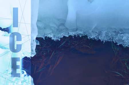 creek running under the snow and iceの写真素材