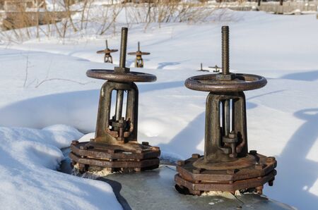 big valves on the pipes, which serve to close the heating mainsの写真素材