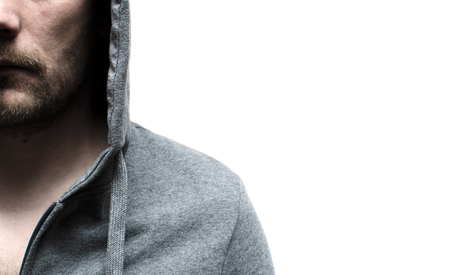 a man in a gray sports jacket with a hoodの写真素材