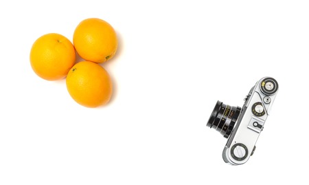 shooting fruits with an old analog camera, isolated on white backgroundの写真素材