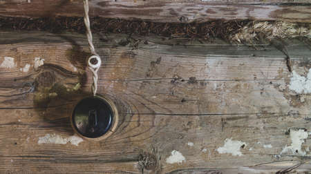 an old switch and an electric wire on an old wooden wall
