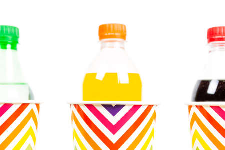 Colorful paper cups and various soda drinks on white.の写真素材