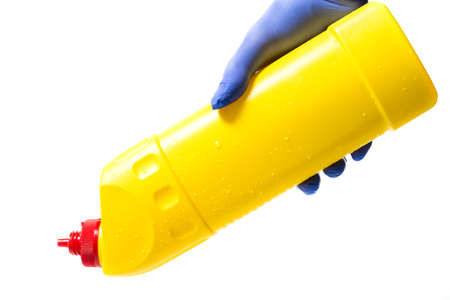 man in gloves holds a bottle with detergent for sinks and bathrooms