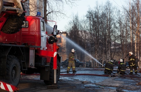 Firefighters extinguish a fire hose from the tap  only editorial