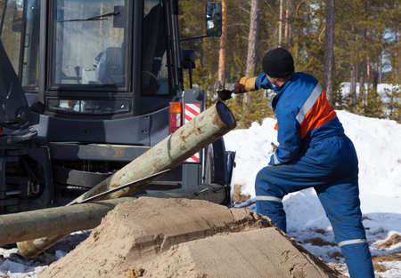 Processing wooden pylon antiseptic before installing into the pit 