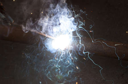 Welding steel pipe, bright light smoke spark electric arc