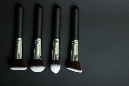 Professional makeup brushes on a black background, natural clothの写真素材
