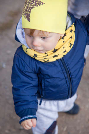 1 years old boy smiling in autumnal scenery