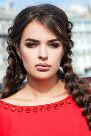beautiful young girl model on the background of the urban landsc