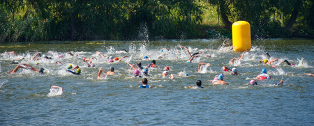 Triathlon Cup of Ukraine and Cup of Bila Tserkva. July 24, 2016 in Bila Tserkva. Group people in wetsuit swimming at triathlonのeditorial素材