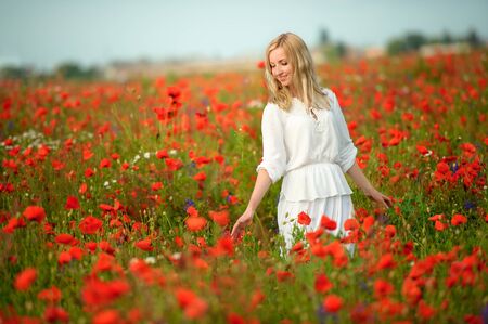 beautiful girl in the poppy fieldの写真素材