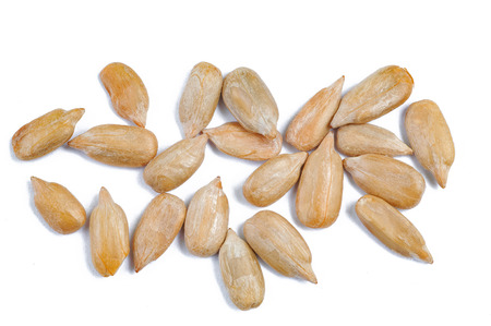peeled sunflower seeds on white surface.の写真素材