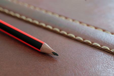 Pencil on leather backgroundの写真素材
