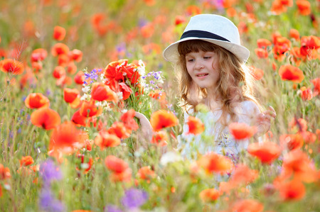 beautiful young girl with flowers and beautiful nature aroundの写真素材