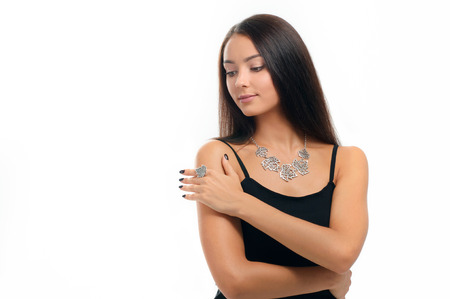 portrait of beautiful woman wearing stylish silver Jewelery. Necklace and finger ring on human model isolated on white の写真素材