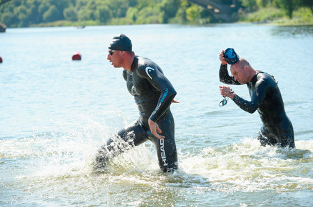 Triathlon Cup of Ukraine and Cup of Bila Tserkva. July 24, 2016 in Bila Tserkva, Ukraine. Swimmers went the distance and close to the finish lineのeditorial素材