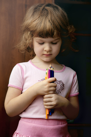 Portrait of the beautiful kid girl with colorful pencil.の写真素材