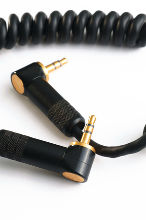 Black audio instrumental cable with two gold stereo plugs isolated on white close upの写真素材
