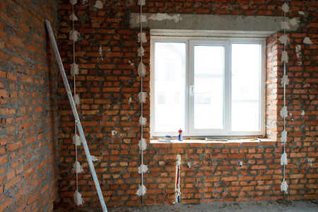 building house. Performed work on electrical wiring and installation of windows, prepared the surface of brick walls to gypsum plasterの写真素材