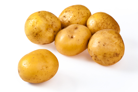 Pile of fresh, yellow, ripe potatoes, isolated on white. Close upの写真素材