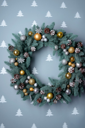 Beautiful and stylish wreath made of decorative toys balls and pine conesの写真素材